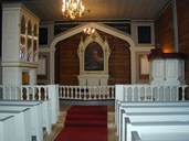 What catches the eye when you enter the Bakka church is the big, new organ (to the left in the picture), placed against the north chancel wall. The village people wanted the organ on the gallery, but were not allowed to do that by the Directorate for Cultural Heritage. The organ was built by Nils Arne Venheim. The pulpit, dating from 1859, rests on the front pew. It is high, with five sections and columns in between.