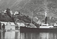 The first hamlet on the way into the fjord from the east is Dyrdal. On 1 May 1926, after a considerable communal effort, the hamlet could take their own quay into use. The picture shows "Kommandøren" docking at the Dyrdal quay. 