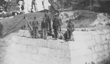 Kaupanger bridge under construction about 1924. In 1924, the old road was rebuilt to the west of the stave church, and a new bridge had to be built. The workers in the picture are: Johan Nyset, Kristin Nondal, Anders Fredheim, Johannes K. Nondal.