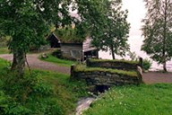 The museum has made it a point that the road through the museum site should be a natural part of the landscape with stone walls and bridges. Next to the lake there is a combined boat-house and barn from Nes in Haukedalen.