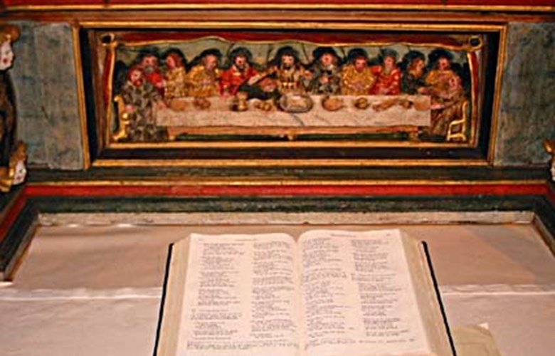 The lowest picture section of the altarpiece represents the holy supper institution. The holy supper is a memorial meal, where one receives Jesus and one's trespasses are forgiven.
