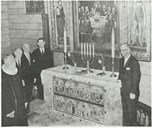 From the handover of the altar frontal - 'antemensal' - on Palm Sunday, 11 April, 1965. The printer J. W. Eide, no. 3 from the left, hands over the frontal to the congregation. The vicar Jostein Hatlebrekke, the mayor Knut Mork, chairman of the 'sokn' council Hans Espeland, and editor Ingemund Fænn at the receiving end.
This altar frontal is a copy made in 1965 of the original frontal from 1310 which belonged to the oldest church in Stryn. The copy is made by the curator Bjørn Kaland and the painter Ole-Gabriel Dahl. The inscriptions on the eight medallions are to be read from left to right, starting at the lower row. All the texts start with the word 'here' and are written in Old Norse. The first inscription is: 'Her byrjar sogin ens helga cros, so kem Kosdroa hernamn han af Jorsalalande til Serklandz.' Translated into English: 'Here starts the story of the Holy Cross. (The Persian king) Cosdroe took the cross by force from the land of Jerusalem to the land of the Saracens.'