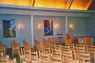 Berle church does not have pews but traditional wooden chairs. On the wall there are two tapestries, .The good shepherd. (left) and .The ten virgins'.