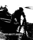 In the 1950s, quite a few cut kelp for sale. This was very hard work, but they saw profit in it. Since it took place on rocks and low spots where the sea waves broke, this work could not be done in turbulent sea.<br />
Here Endre and Søren Storøy are out in the Nordfjord-built rowboat cutting kelp to the west of Storøy. They cut the kelp with a short scythe. They dried it on the rocks and brought it to a shed where it was stored until it was shipped out. Since 1954, there has been a receiving station for kelp at Buskøy.