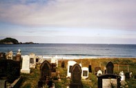 Recent gravestones at the Ervik churchyard. In the background the open waters of Stadhavet. The graveyard by the ocean, Dagfred Berstad has entitled an article in the congregational magazine.