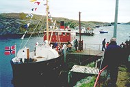 For the centenary celebration of the lighthouse on 15 November, 1999, the veteran ship 'Atløy' came to Utvær, here seen at the lighthouse quay. The quay, 'a stone quay with a lever for unloading goods', appears quite high, built before the jetty. However, in periods of stormy weather, there can still be high swells and surges in the bay area, which explains why the boathouse foundations were built considerably higher than in more protected and sheltered harbours.