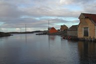 Husøy seen toward north-west and the bay. The bay is shallow, but deep enough for the privateer's ships boat. The privateer itself probably had to cast anchor further out, sheltered by the islets. The large house was located behind the stalls, with a view of the bay.