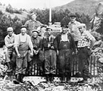 A team of workers lined up in front of the bulldozer. With the exception of the driver, Berge, they are all from Solund. The picture is believed to have been taken near Pollen in the middle of the 1950s. The foreman is Bernt Hopsdal, no. 3 from the left.
