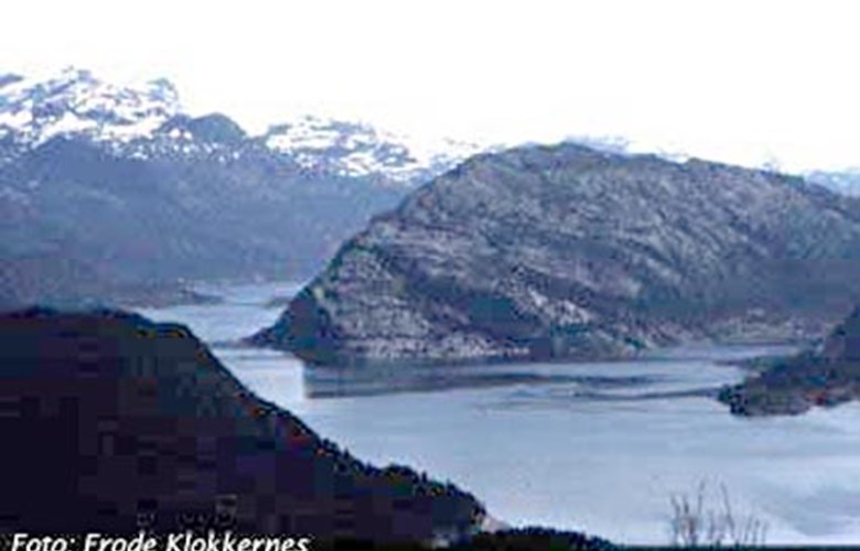 The point of Stakaldeneset seen from the west. The southern bay south (to the right) of the point is Sandvika. North (to the left) of Stakaldeneset we see the strait of Helgøysundet leading into the Eikefjord.