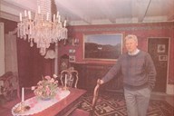 The then chairman of the board of the Svanøy Foundation, professor Eigil Reimers, in the biggest living room in the main building. In this room and in the adjoining rooms most of the cultural treasures are displayed. 