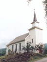 Nordal church is a simple white-painted longchurch built of cog-joint logs with horizontal panelling. The church marks a dignified conclusion to the most active church-construction period in the county of Sogn og Fjordane in recent times.