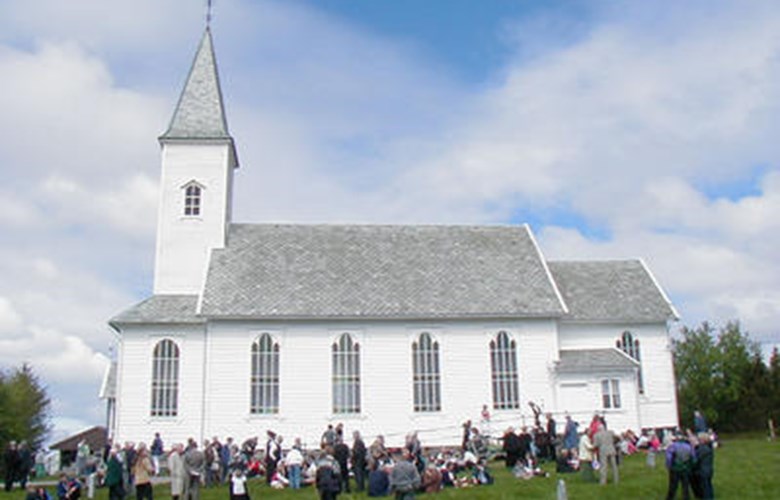 On a former outlying field on the island of Mjømna the islanders erected a plain but elegant church in 1901. The picture was taken at the church centenary / centennial in 2001.