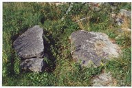Two stones at the mountain farm. It looks as if these have served a purpose and Bjørg Lidal knows something about them. This is 'Klyvjasteinen'. - The packhorse was led in between these two stones in order to make it easier to load or unload the horse, she says.