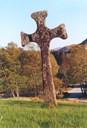 The other stone cross at Eivindvik, referred to as the Anglian cross, stands a few hundred metres north of the Celtic cross by the church. The Anglian cross is characterized by rounded forms in contrast to the straight lines of the Celtic cross.