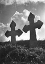 Many tombstones are made of suitable stone material found locally. These are two of several slate crosses without any inscription.