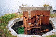 These are the remains of a 50mm "Kampfwagenkanone" that was normally used in the close defence of German coastal forts. Only the gun barrel and the aiming mechanism are missing.