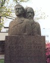 The double bust of the Sars brothers is placed on a stone plinth in the city park, between "Samfunnshuset" and Victoria Hotel. It is a gift from the "emigrants" from Florø for the city centenary in 1960, carried out by the sculptor Eilif Mikkelsen who was present at the unveiling ceremony on 16 May 1960.