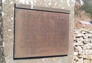 The metal plaque on the stone and the inscription: RASMUS M. R. NYVOLL * Born 2 August 1909 * fell in action for his country in * Italy 24 May 1944 * In gratitude for his sacrifice * the home village has erected this * memorial