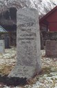 The memorial stone on the grave of Hans Seip in Fjærland. The inscription at the back: THE COUNTY ERECTED THIS STONE<br />
The stone came from Viksdalen in Gaular and the teacher Harald Bell was the contact person for the county governor. Bell asked Lars Hoff to get hold of the stone and write the inscription. Hoff even went to Fjærland and made sure that the stone was firmly placed on a concrete foundation.<br />    
The stone at the foot marks his wife Inga, and his sister Thorunn.
