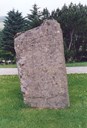 The Christen Jenssøn stone in 2001, seen from behind. Here are carved characters as well. Wear and tear is the reason that the characters are not very distinct. Ragnar Bull, Holmedal, thinks they read: GBDK ANNO 1735. He likes to think also that the stone has been used twice, first over CIS in 1653, and then, in 1735, over another person. In 2001, the stone slants a little toward the west, compared to its original position.